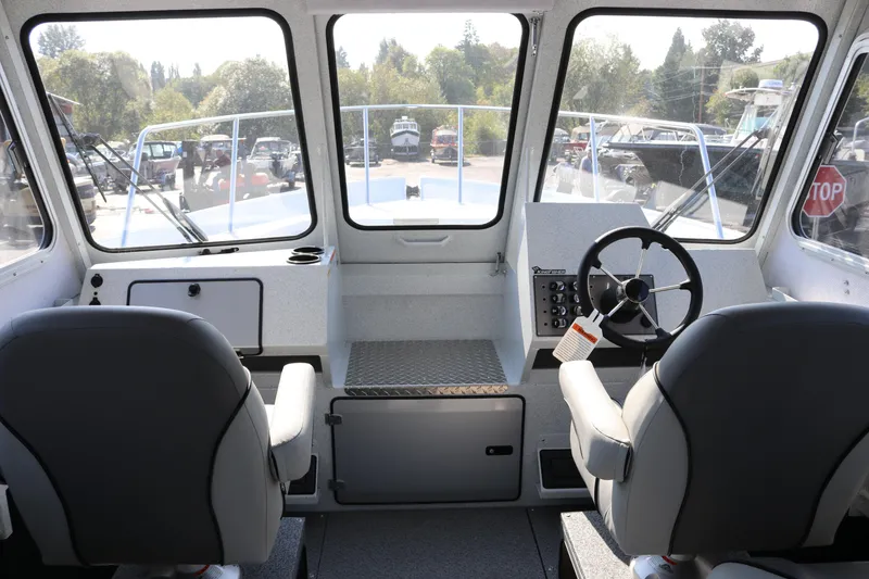 Slide: The Image of Interior view of 2026 KingFisher 2425 Escape HT boat cockpit with dual seats and steering wheel. - 17