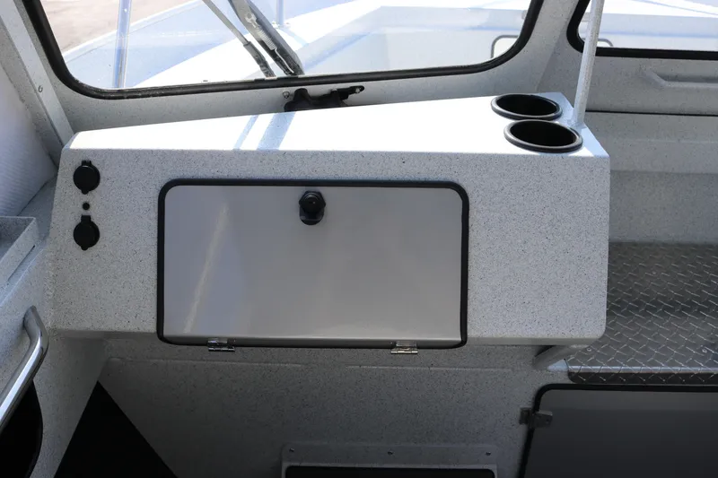 Slide: The Image of Interior of 2026 KingFisher 2425 Escape HT boat with storage compartment and cup holders. - 20