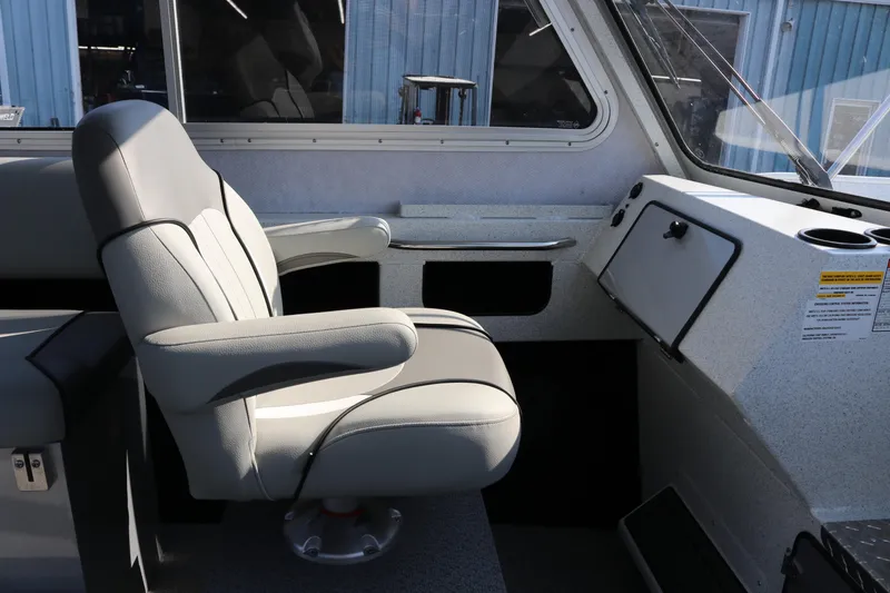 Slide: The Image of Interior of 2026 KingFisher 2425 Escape HT boat, featuring a comfortable captain's chair. - 24