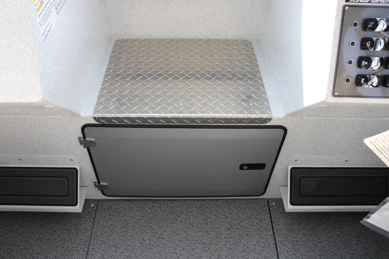 Slide: The Image of Interior view of 2026 KingFisher 2425 Escape HT boat, featuring storage compartment and control panel. - 25