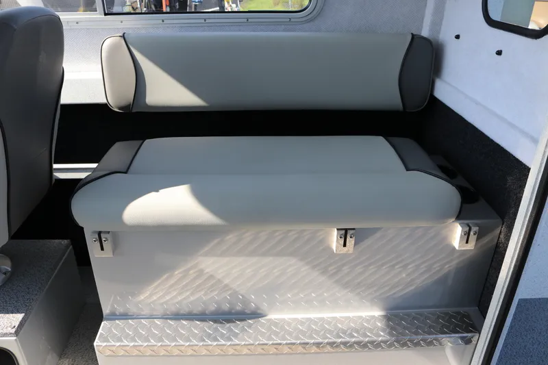 Slide: The Image of Interior seating of 2026 KingFisher 2425 Escape HT boat, featuring cushioned bench and storage. - 29