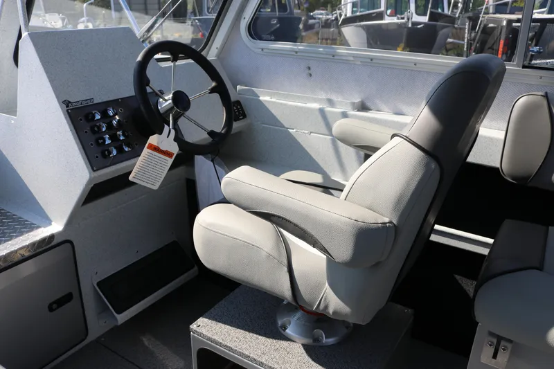 Slide: The Image of Interior of 2026 KingFisher 2425 Escape HT boat, featuring steering wheel and captain's chair. - 30