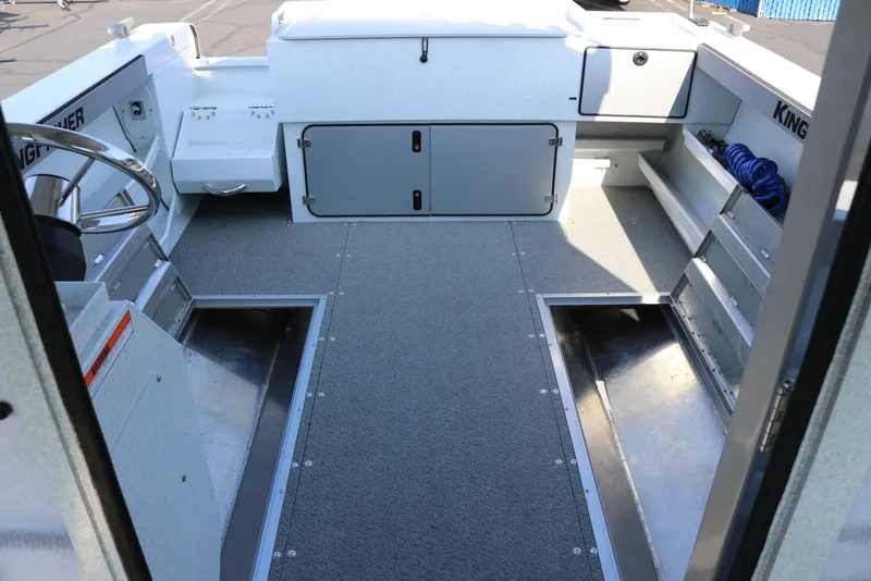 Slide: The Image of Interior view of 2026 KingFisher 2425 Escape HT boat, featuring spacious deck and storage compartments. - 33