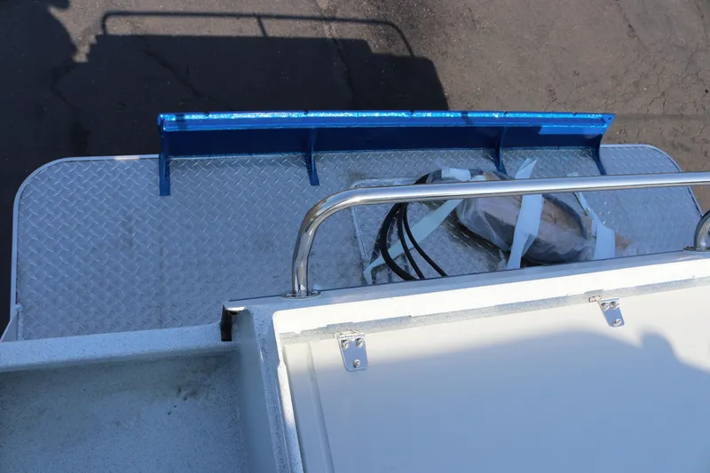 Slide: The Image of Rear deck of 2026 KingFisher 2425 Escape HT boat with metal railing and storage area. - 34