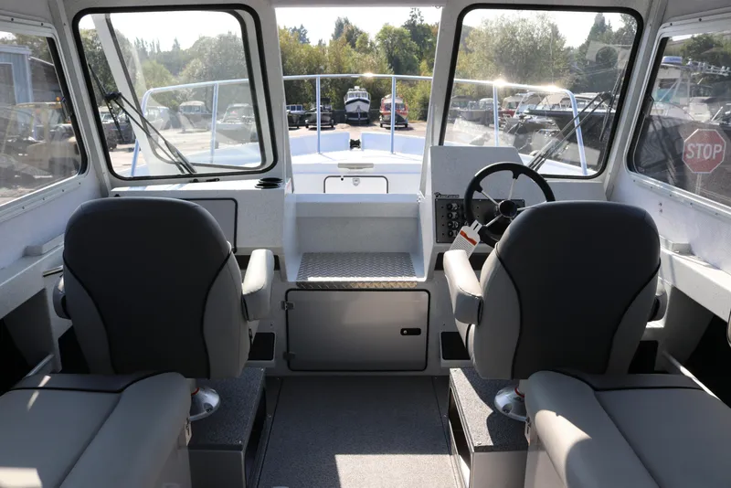 Slide: The Image of Interior of 2026 KingFisher 2425 Escape HT boat with dual seats and steering wheel. - 37