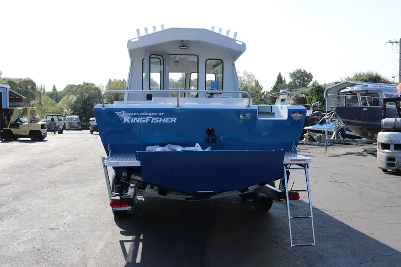 Slide: The Image of 2026 KingFisher 2425 Escape HT boat, rear view in a marina setting. - 4