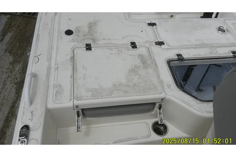 Slide: The Image of 2023 Mako Pro Skiff 19 CC boat deck with storage compartments and seating. - 10