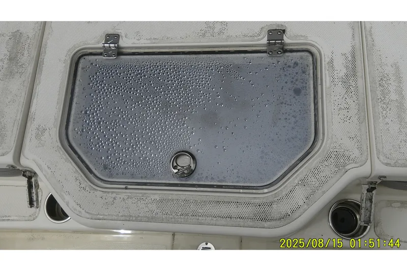 Slide: The Image of 2023 Mako Pro Skiff 19 CC boat hatch with condensation droplets. - 12