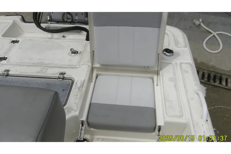 Slide: The Image of 2023 Mako Pro Skiff 19 CC boat seating and storage area. - 13