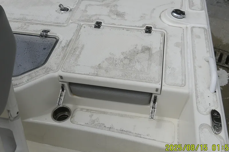 Slide: The Image of 2023 Mako Pro Skiff 19 CC boat deck with storage compartments and cup holder. - 14