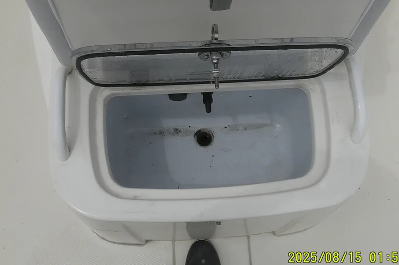 Slide: The Image of Open storage compartment on a 2023 Mako Pro Skiff 19 CC boat. - 18