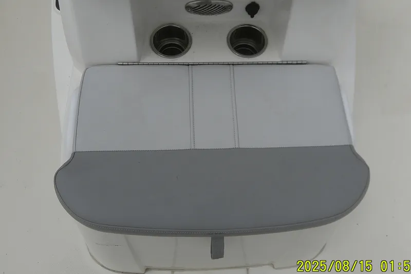Slide: The Image of 2023 Mako Pro Skiff 19 CC boat seat with cup holders and storage compartment. - 20