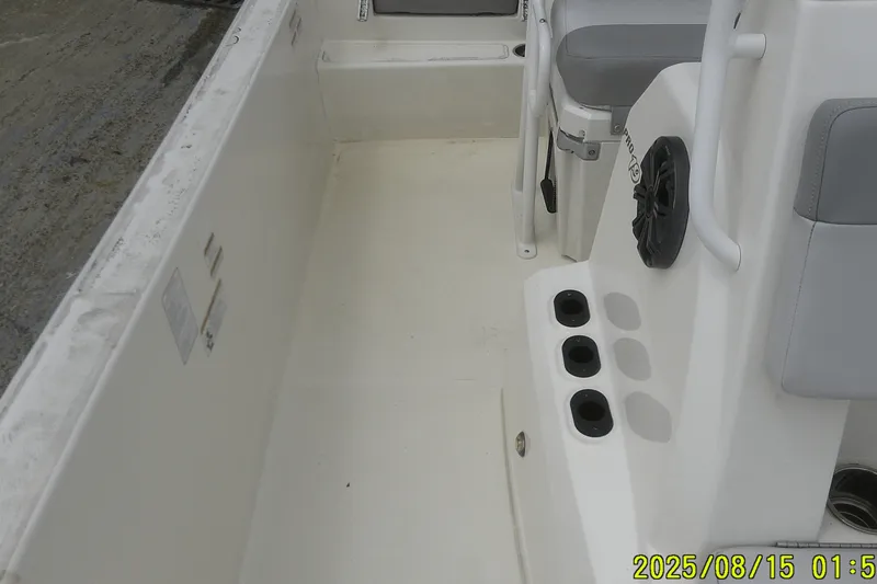 Slide: The Image of 2023 Mako Pro Skiff 19 CC interior with seating and rod holders. - 21