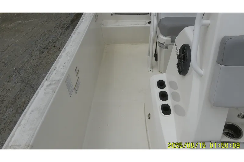 Slide: The Image of 2023 Mako Pro Skiff 19 CC interior with seating and rod holders. - 22