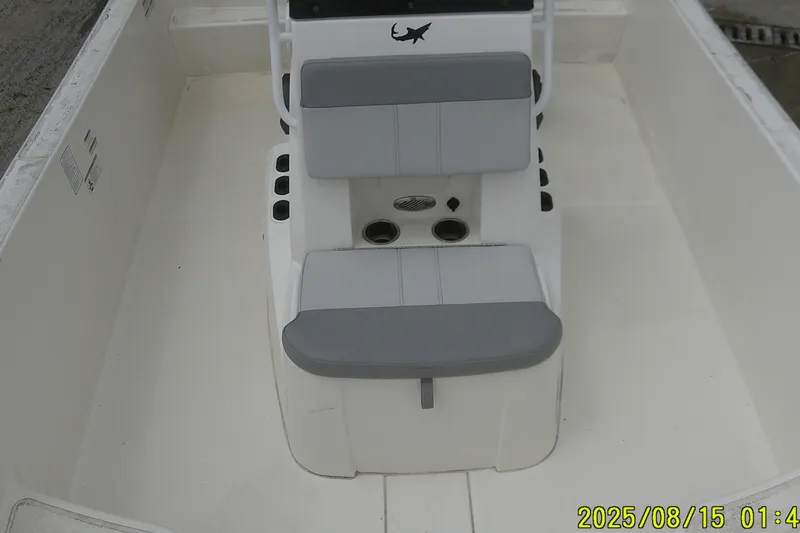 Slide: The Image of 2023 Mako Pro Skiff 19 CC boat interior with gray seating and console. - 24