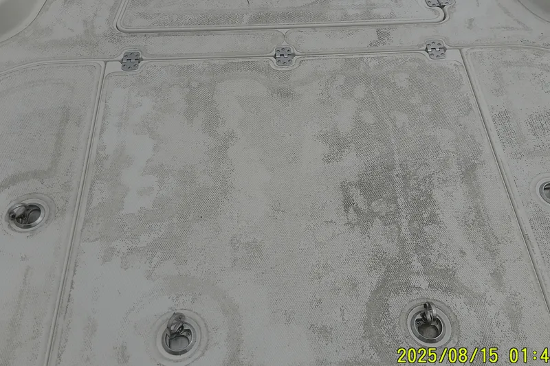 Slide: The Image of 2023 Mako Pro Skiff 19 CC deck with textured surface and metal fixtures. - 26