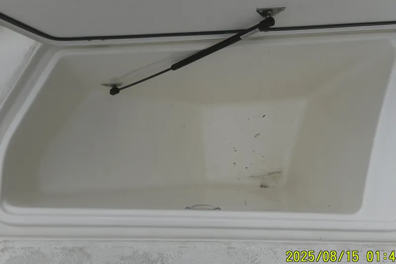 Slide: The Image of Open storage compartment of 2023 Mako Pro Skiff 19 CC boat. - 27
