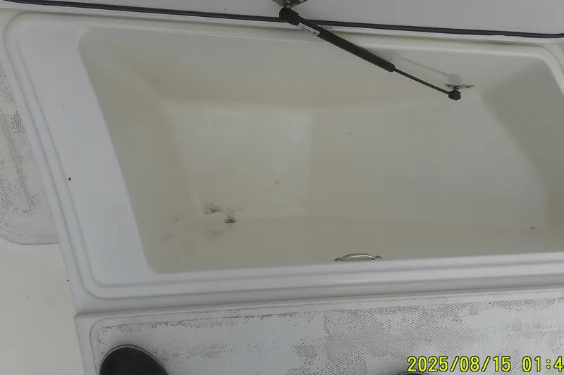 Slide: The Image of 2023 Mako Pro Skiff 19 CC storage compartment with hydraulic lift support. - 29