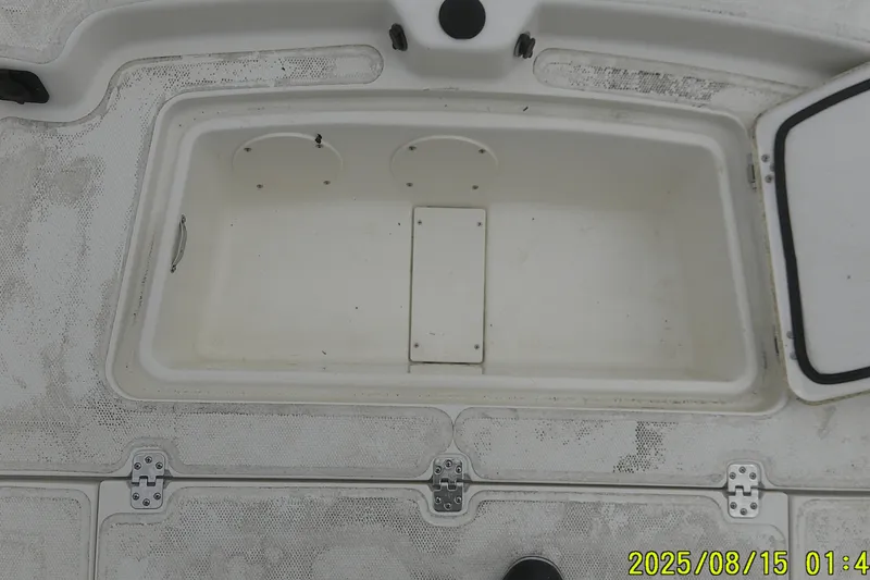 Slide: The Image of Open storage compartment on a 2023 Mako Pro Skiff 19 CC boat. - 31