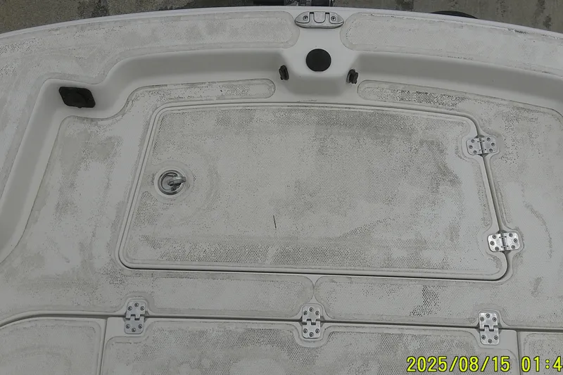 Slide: The Image of 2023 Mako Pro Skiff 19 CC boat deck with storage hatch and hinges. - 32