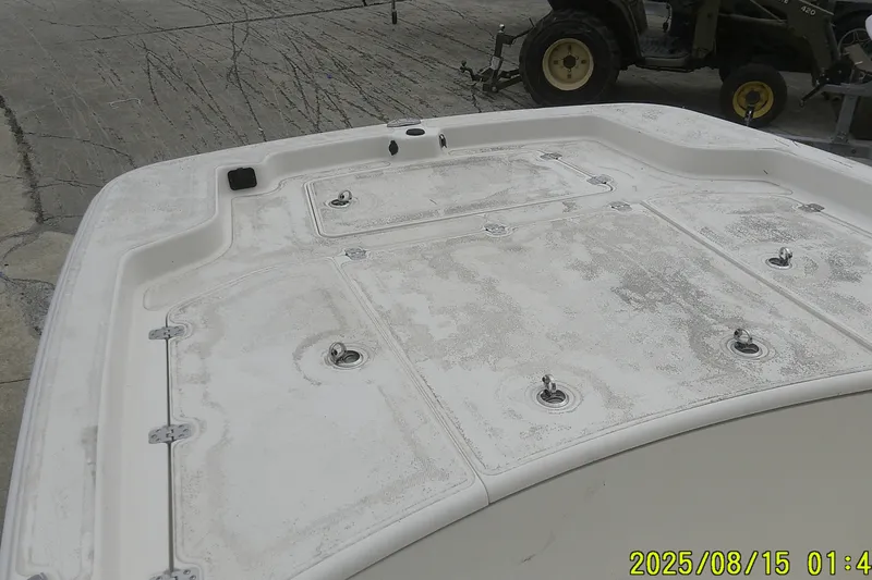 Slide: The Image of 2023 Mako Pro Skiff 19 CC boat deck, showing storage compartments and hardware. - 33