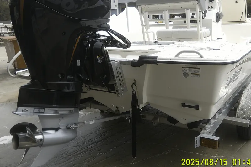 Slide: The Image of 2023 Mako Pro Skiff 19 CC boat on trailer, rear view with outboard motor. - 35