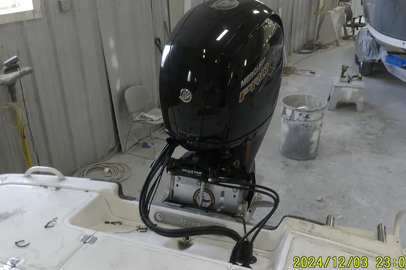 Slide: The Image of 2023 Mako Pro Skiff 19 CC with Mercury Pro outboard motor in workshop. - 46