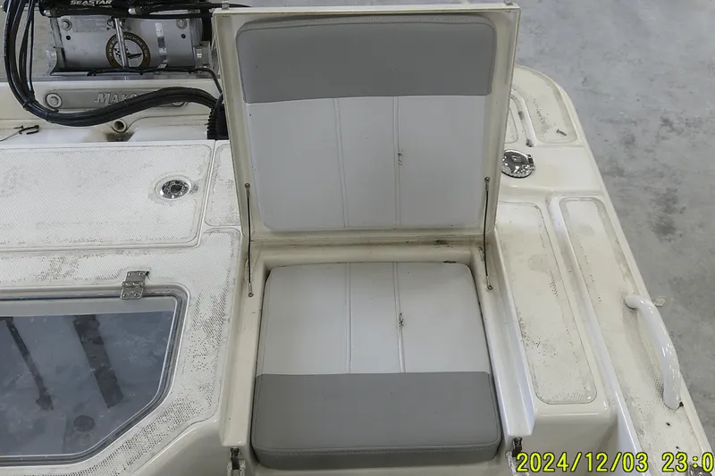 Slide: The Image of 2023 Mako Pro Skiff 19 CC boat seat and storage compartment detail. - 47