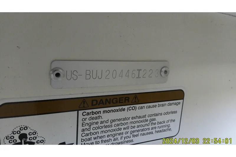 Slide: The Image of 2023 Mako Pro Skiff 19 CC hull identification number and carbon monoxide warning label. - 5