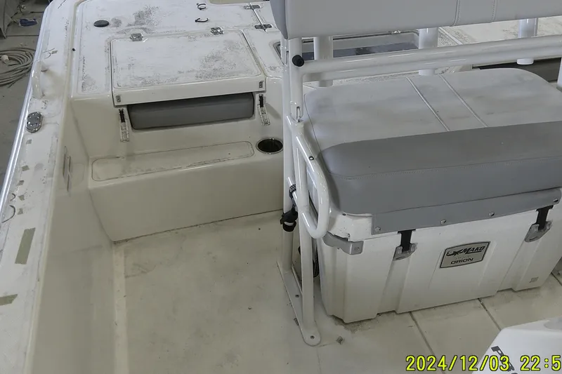 Slide: The Image of 2023 Mako Pro Skiff 19 CC interior with seating and storage compartments. - 52