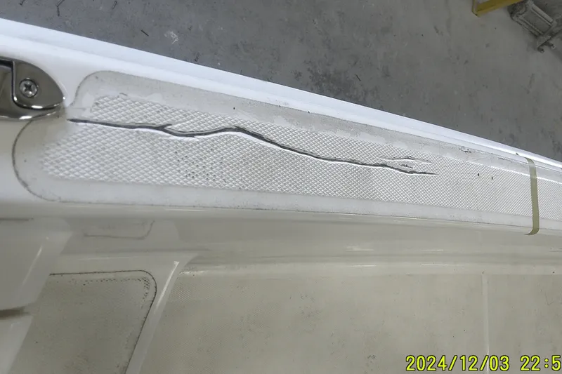 Slide: The Image of Cracked surface on 2023 Mako Pro Skiff 19 CC boat, showing damage detail. - 53