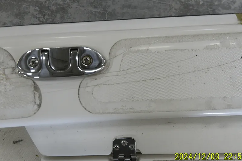 Slide: The Image of 2023 Mako Pro Skiff 19 CC boat detail showing metal cleat and textured surface. - 56