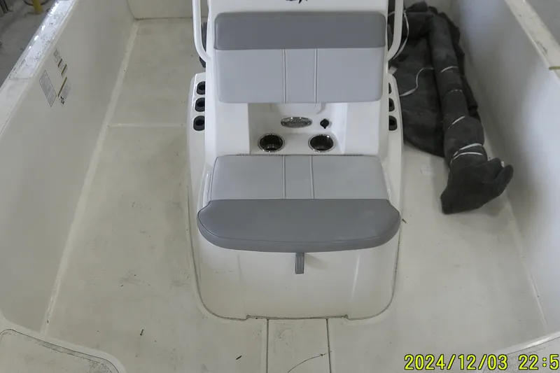 Slide: The Image of 2023 Mako Pro Skiff 19 CC interior with seating and storage compartments. - 59