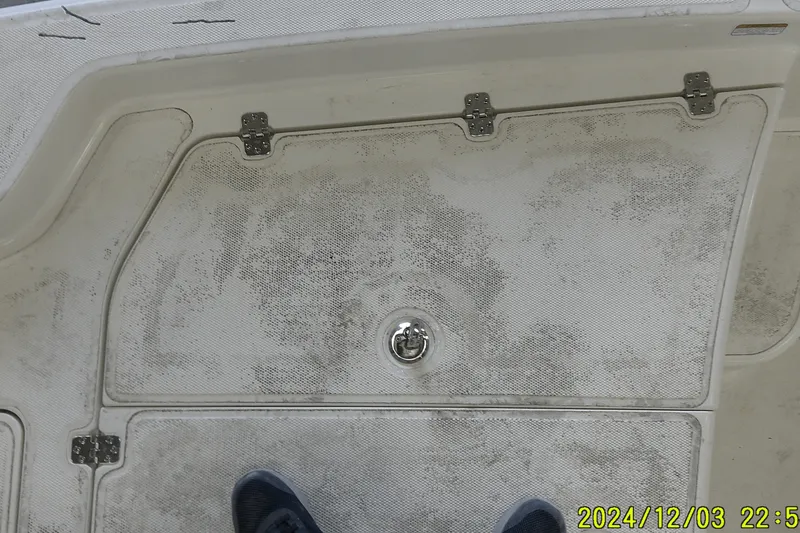 Slide: The Image of 2023 Mako Pro Skiff 19 CC deck with storage hatch and hinges. - 62