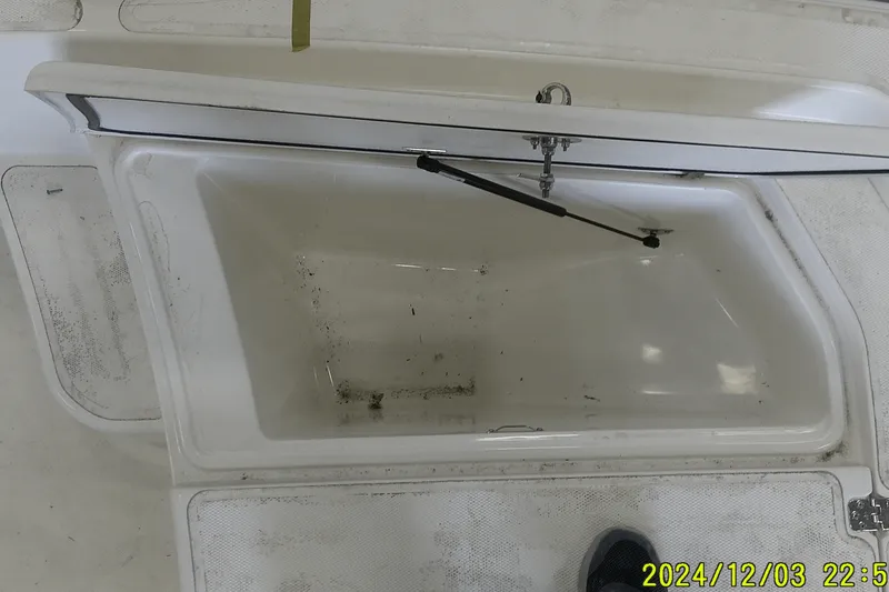 Slide: The Image of Open storage compartment on 2023 Mako Pro Skiff 19 CC boat. - 64