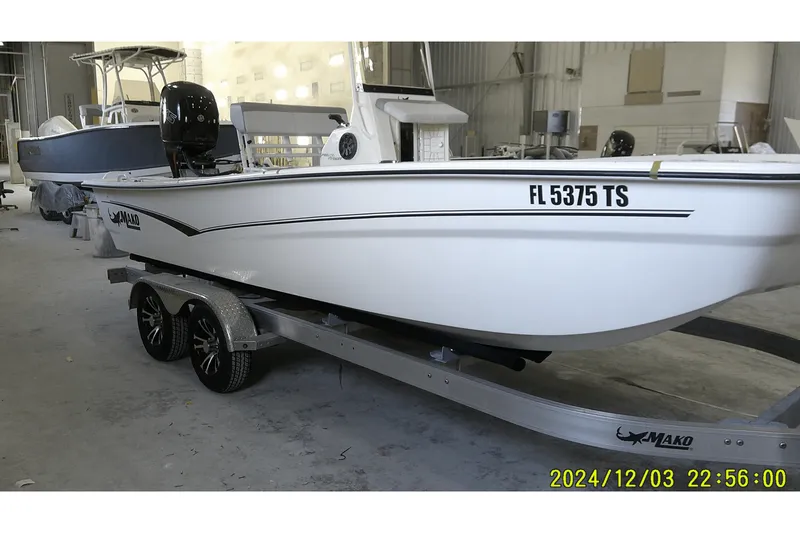 Slide: The Image of 2023 Mako Pro Skiff 19 CC boat on trailer in a warehouse setting. - 68