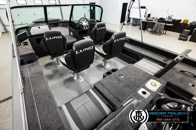 Slide: The Image of 2026 Lund 1875 Impact XS boat interior with four seats and steering console. - 10