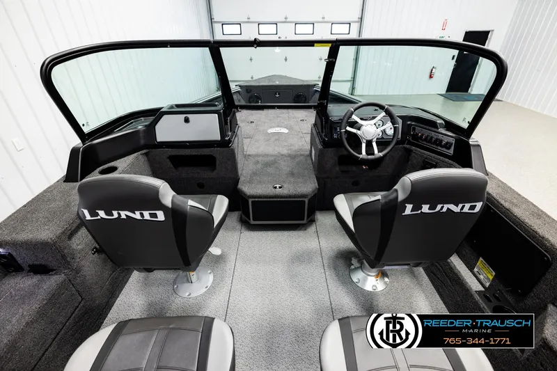 Slide: The Image of 2026 Lund 1875 Impact XS boat interior with steering wheel and seating. - 13