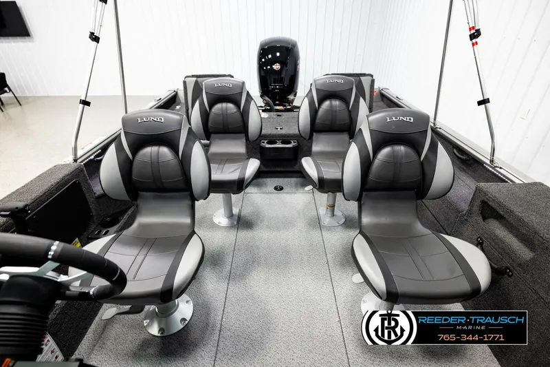 Slide: The Image of 2026 Lund 1875 Impact XS boat interior with four gray seats and steering wheel. - 16
