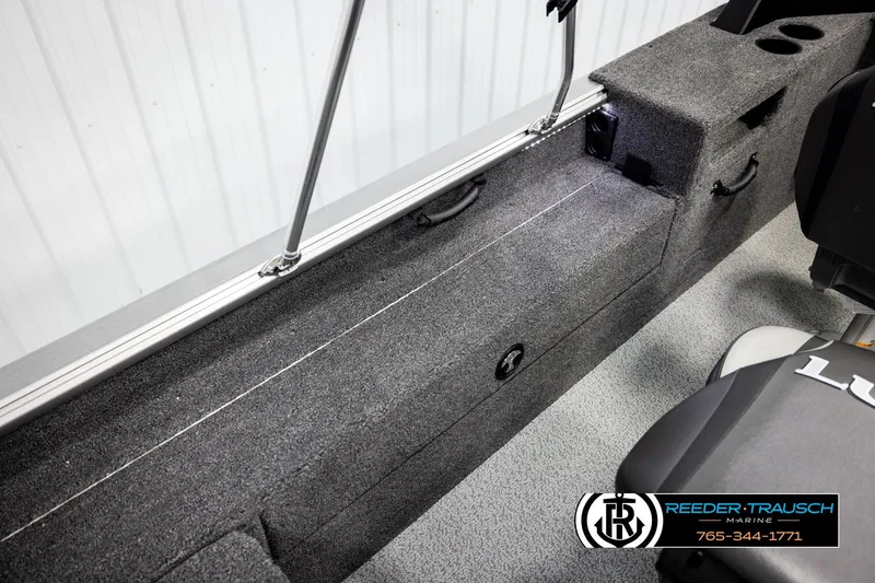 Slide: The Image of Interior view of 2026 Lund 1875 Impact XS boat with carpeted storage and seating. - 22