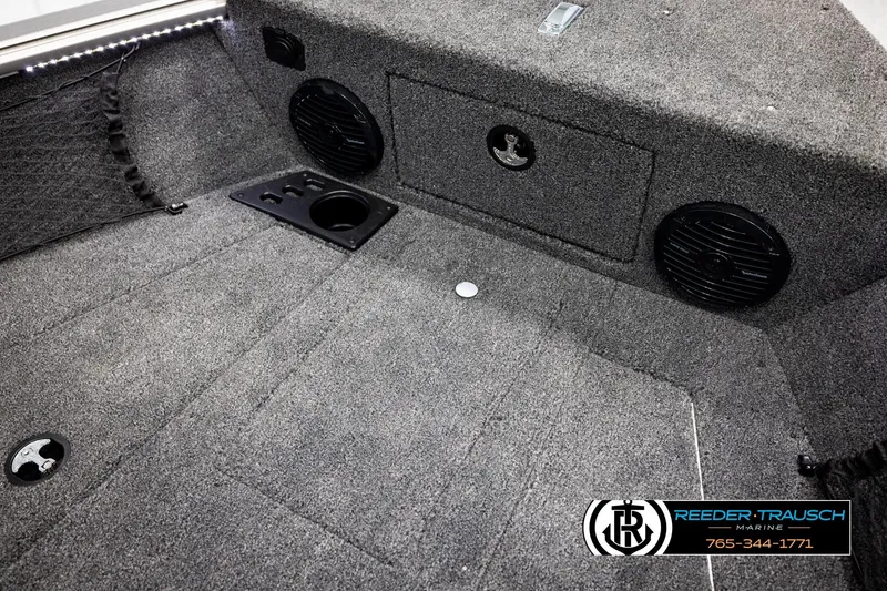 Slide: The Image of Interior of 2026 Lund 1875 Impact XS boat with carpeted flooring and speakers. - 26