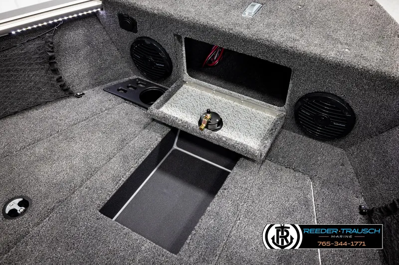 Slide: The Image of 2026 Lund 1875 Impact XS boat interior with speakers and storage compartments. - 27