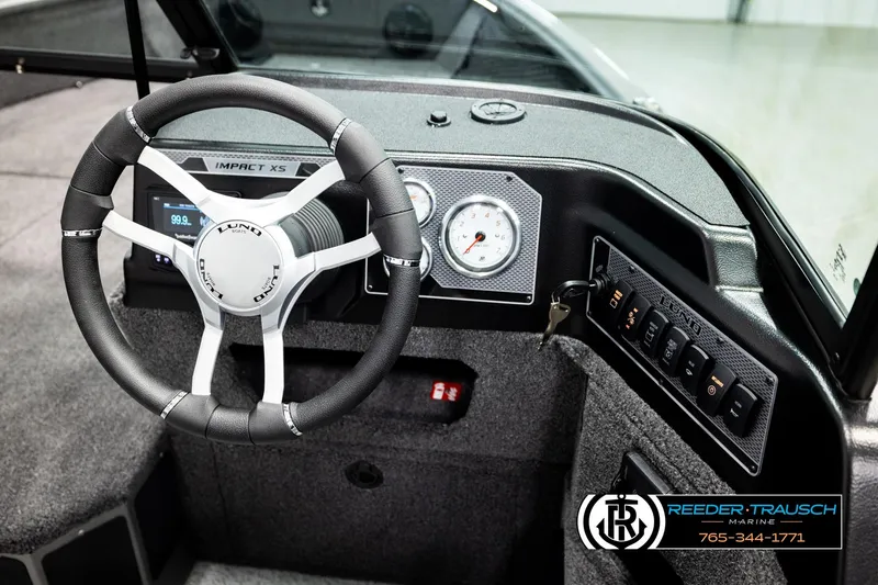 Slide: The Image of 2026 Lund 1875 Impact XS boat dashboard with steering wheel and control panel. - 32