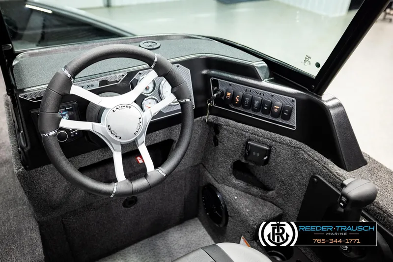 Slide: The Image of Interior of 2026 Lund 1875 Impact XS boat with steering wheel and control panel. - 33