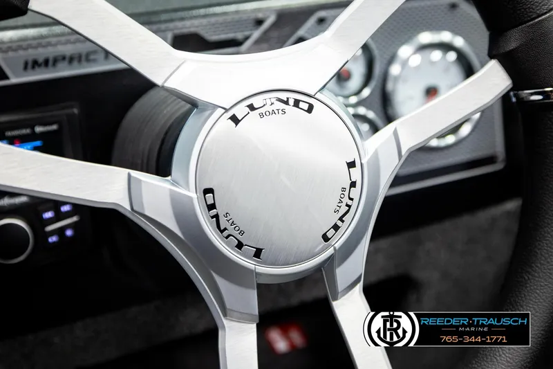 Slide: The Image of Steering wheel of 2026 Lund 1875 Impact XS boat with dashboard details. - 34