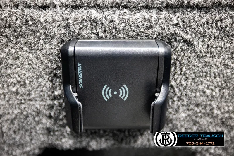 Slide: The Image of Wireless charging pad on 2026 Lund 1875 Impact XS boat, textured surface background. - 38