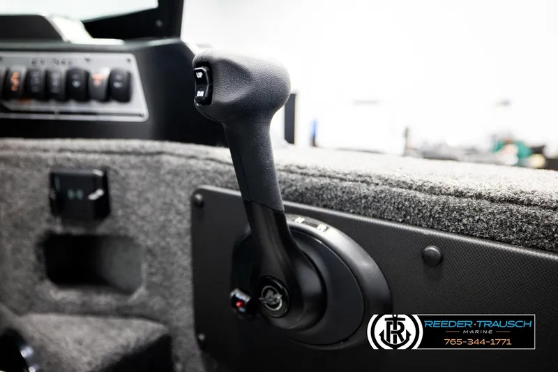 Slide: The Image of Close-up of 2026 Lund 1875 Impact XS boat throttle control. - 39