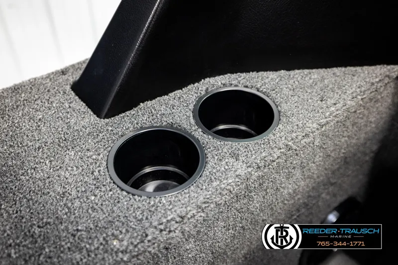 Slide: The Image of Cup holders on 2026 Lund 1875 Impact XS boat with gray carpet interior. - 44