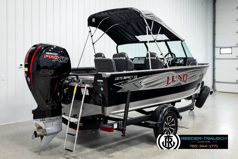 Slide: The Image of 2026 Lund 1875 Impact XS boat with Mercury Pro XS engine in showroom. - 5