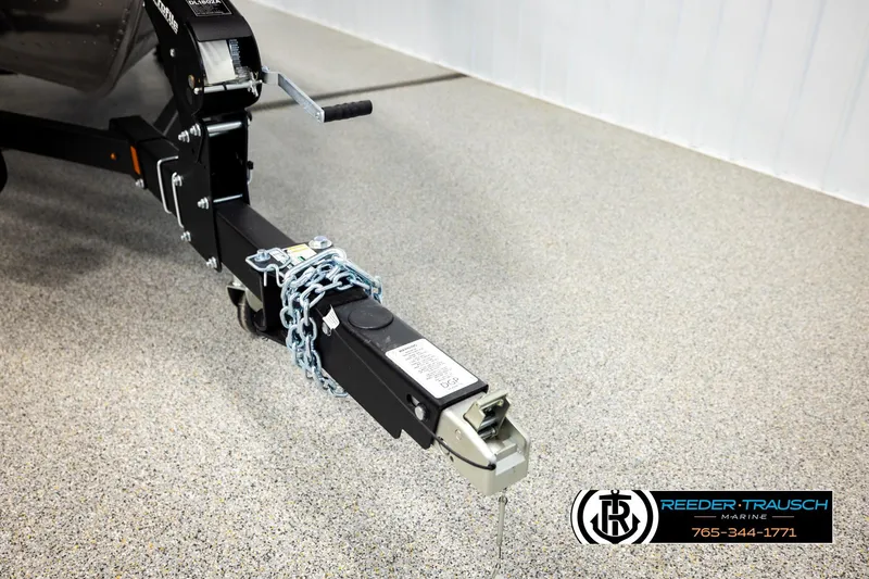 Slide: The Image of Trailer hitch of 2026 Lund 1875 Impact XS with chain lock on showroom floor. - 52